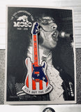 metal guitar pin in red, white and blue hard enamel with a black and white photo card back