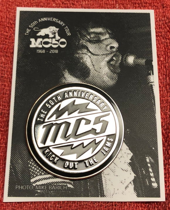 MC5 chrome and black hard enamel pin WITH lightening bolts on photo background